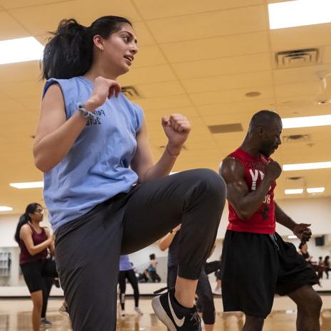 Male and female student in group fitness session