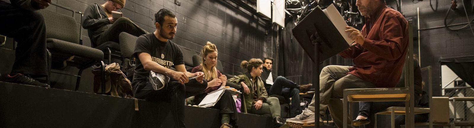 Students sitting in a class on stage.