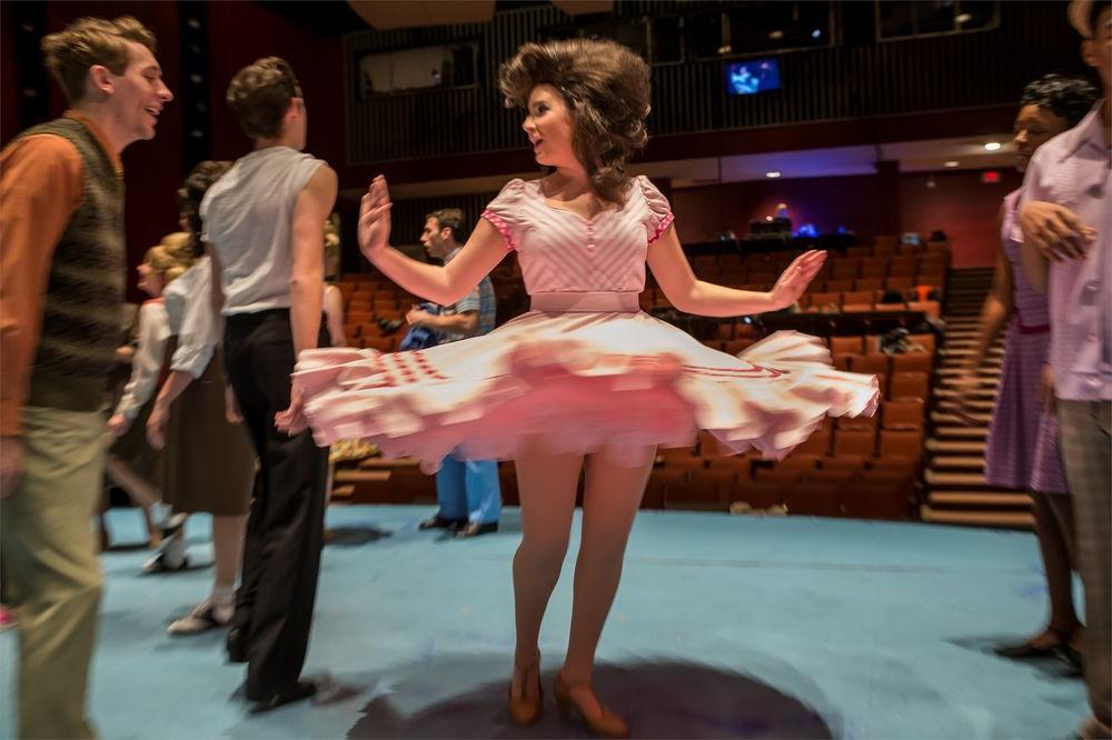 Actor twirling her dress on stage