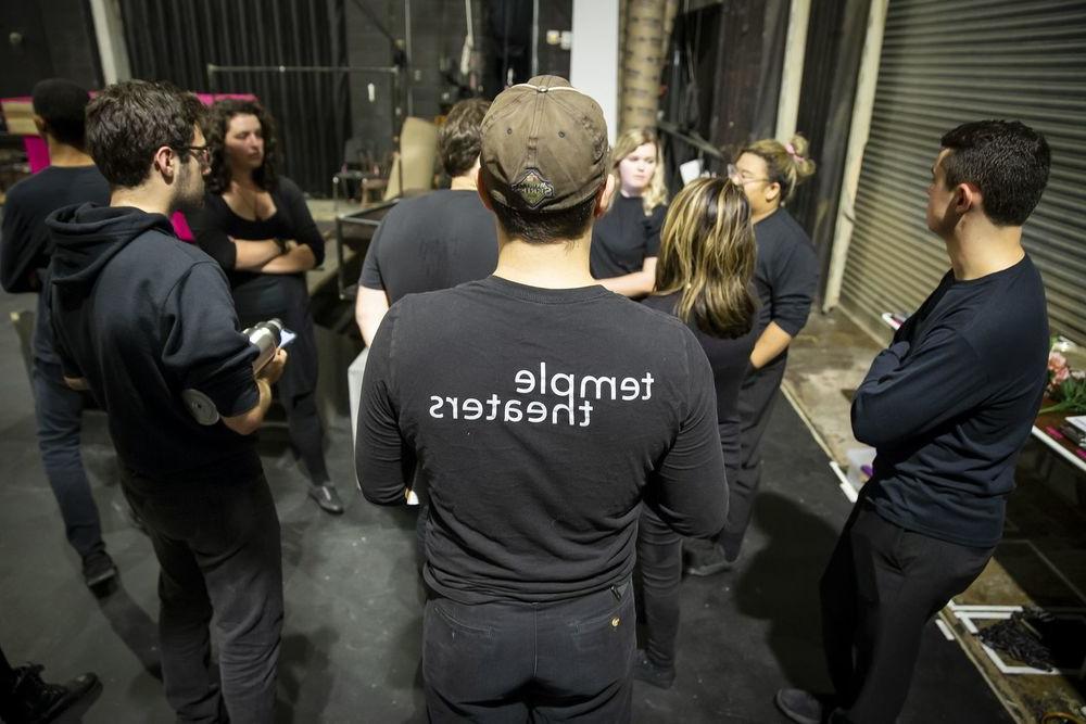 The stage crew standing in a group together.